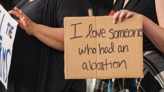 Protest sign reads "I love someone who had an abortion"